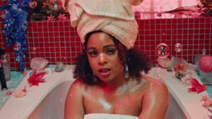 A Black woman takes a luxurious bubble bath.